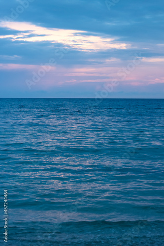 portrait photo of the coastline  with clouds and purplish-blue sky