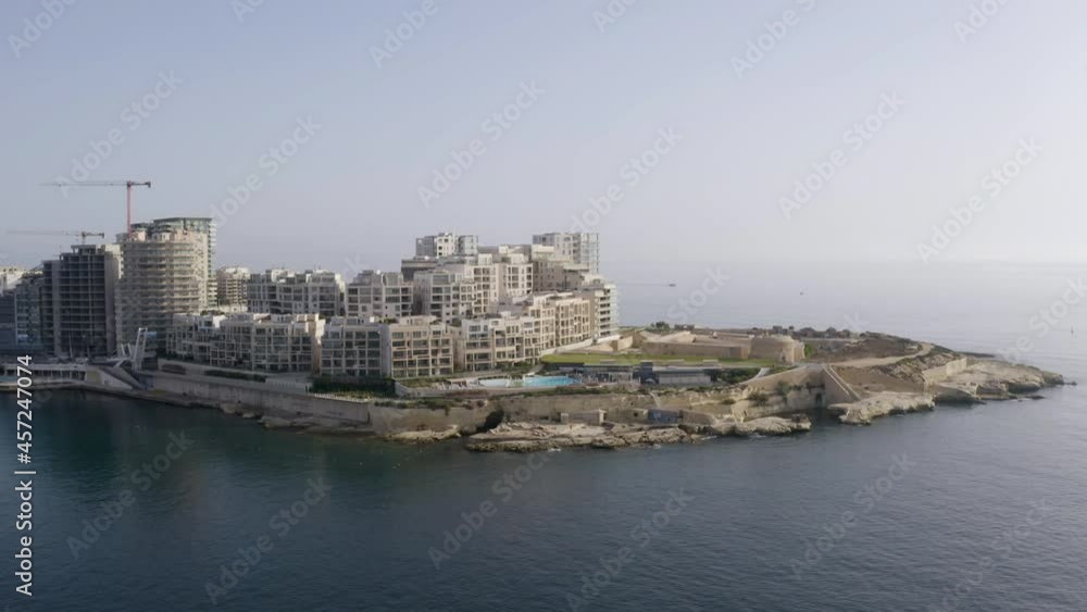 Apartment complex on a small peninsula in Valletta city,Malta,aerial. Apartment complex on a small peninsula in Valletta city,Malta,aerial.