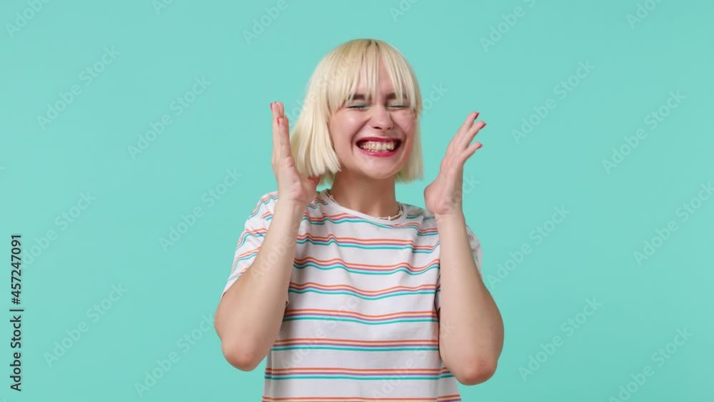 Shocked young blonde short haircut woman 20s years old wears striped t-shirt say wow omg what spreading hands put arms on face screech isolated on pastel plain light blue background studio portrait Shocked young blonde short haircut woman 20s years old wears striped t-shirt say wow omg what spreading hands put arms on face screech isolated on pastel plain light blue background studio portrait