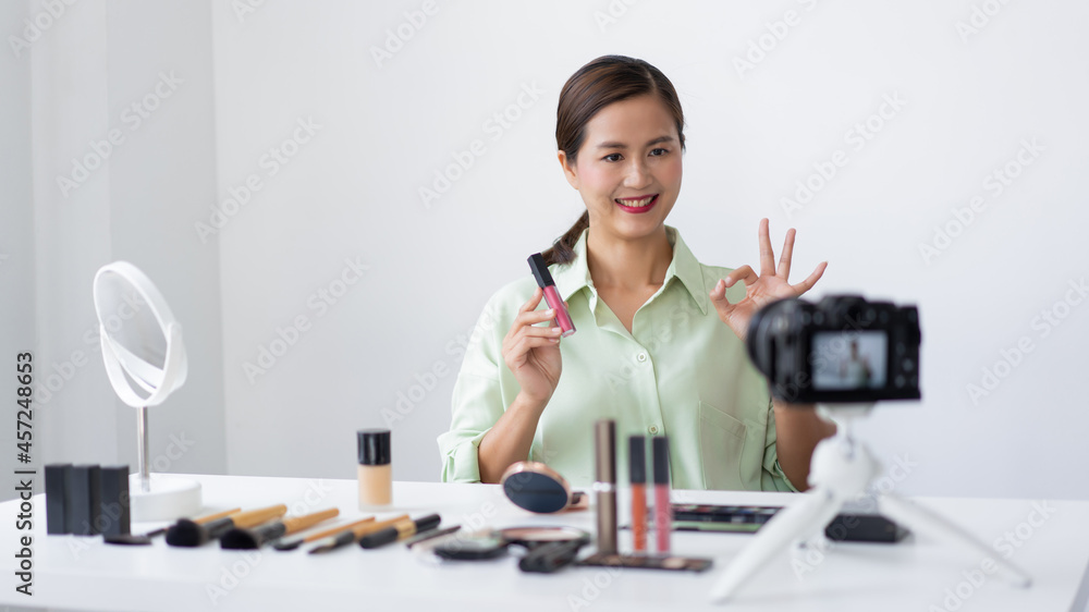 A confident beauty blogger showing a pink liquid lipstick claiming the quality of the product A confident beauty blogger showing a pink liquid lipstick claiming the quality of the product