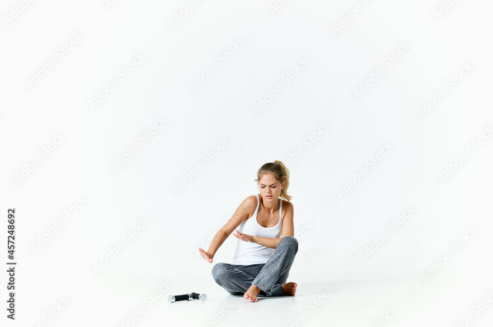 woman sitting barefoot on the floor dumbbells in hands exercise muscles workout woman sitting barefoot on the floor dumbbells in hands exercise muscles workout