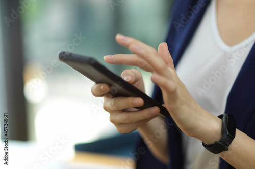 Cropped image, closeup of businesswoman use modern smartphone text or message