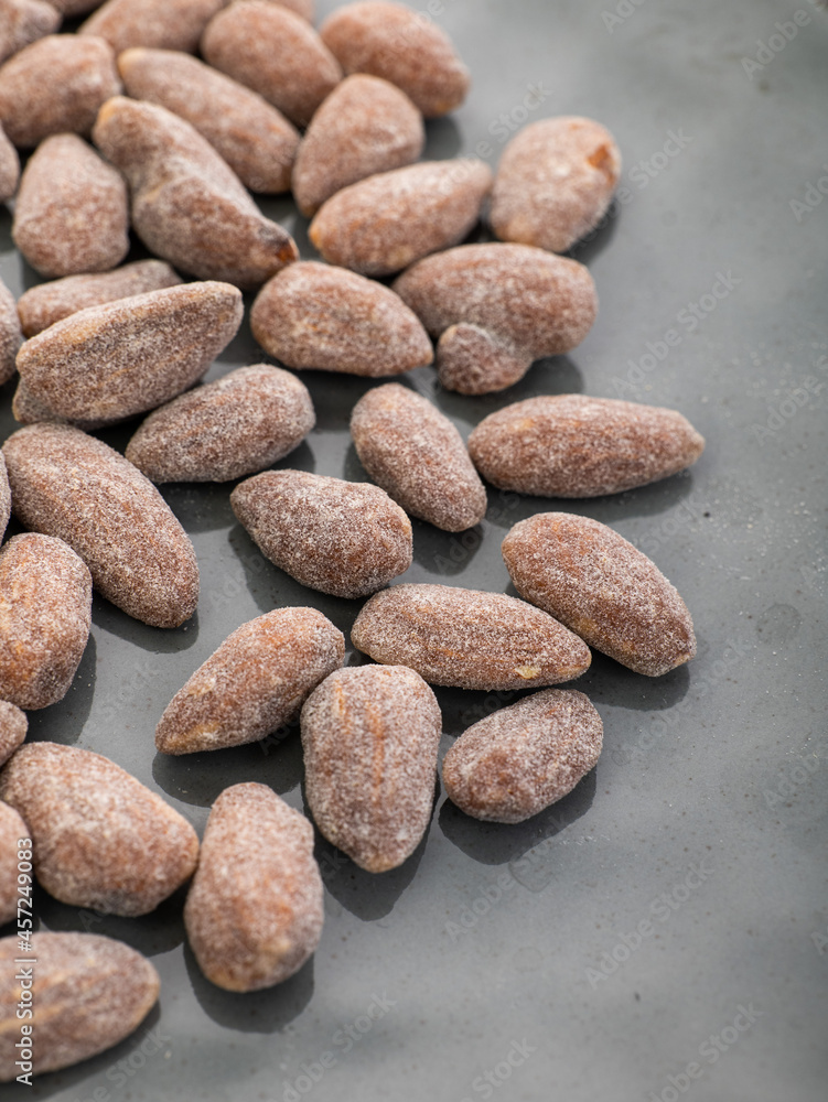 almonds with sweet sprinkles on a plate on a white background almonds with sweet sprinkles on a plate on a white background