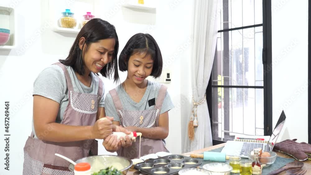 happy family asian Mother and daughter cooking in the kitchen at home happy family asian Mother and daughter cooking in the kitchen at home