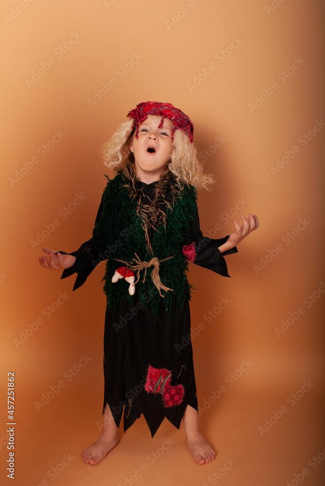 a little girl in the image of Baba Yaga on Halloween depicts loud laughter for advertising on the holiday of evil spirits a little girl in the image of Baba Yaga on Halloween depicts loud laughter for advertising on the holiday of evil spirits