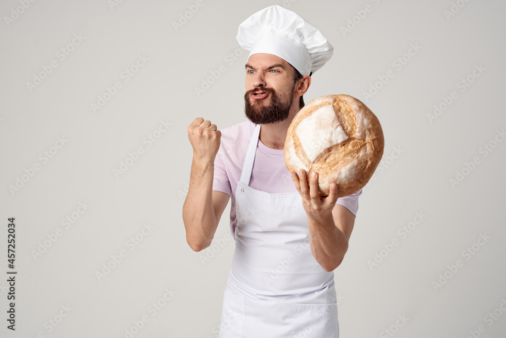 a man in a white apron with bread in his hands cooking cooking food a man in a white apron with bread in his hands cooking cooking food