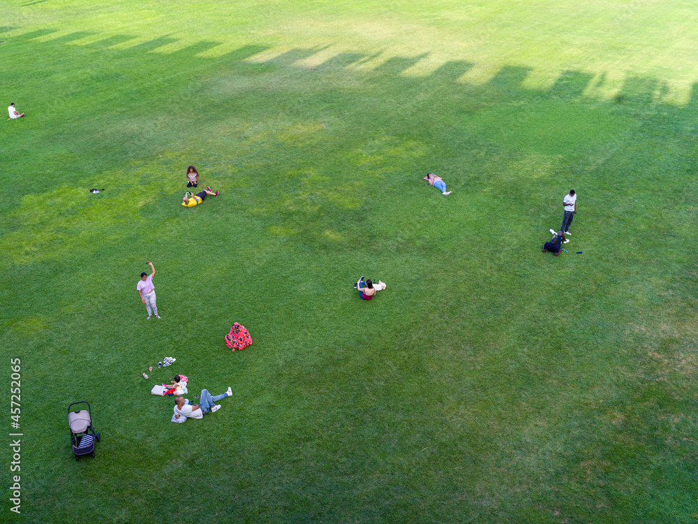 Texture of a green lawn with people, seen from above Texture of a green lawn with people, seen from above