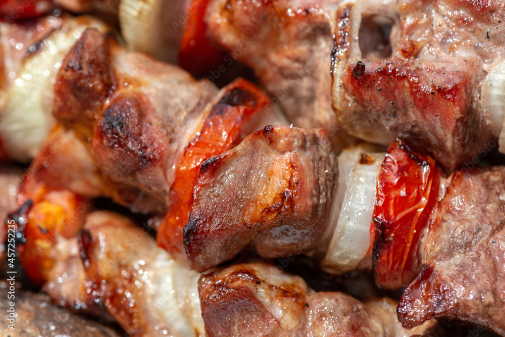 traditional barbecue meat with onions and tomatoes, close up