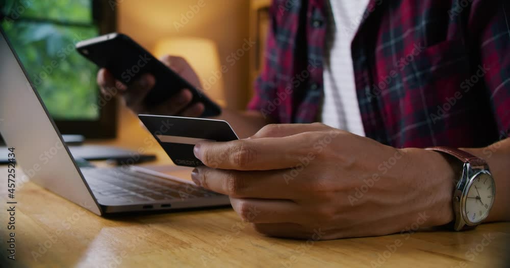 Young man making payment and shopping by credit card, online business and home shopping concept. Young man making payment and shopping by credit card, online business and home shopping concept.
