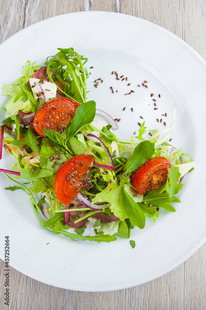 salad with herbs and tomatoes on a plate
salad with herbs and tomatoes on a plate