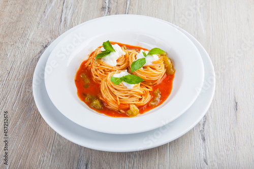 pasta in tomato sauce with curd sauce and basil