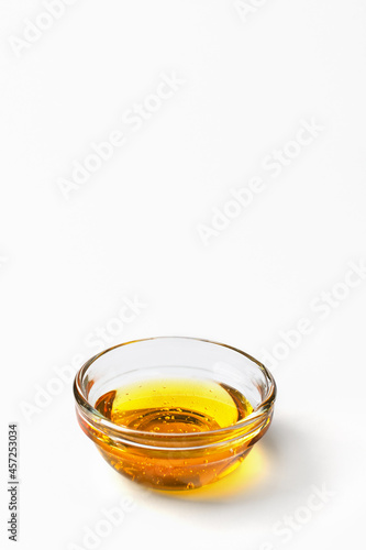 Healthy organic honey in a bowl on white background. Sweet honey healthy dessert.