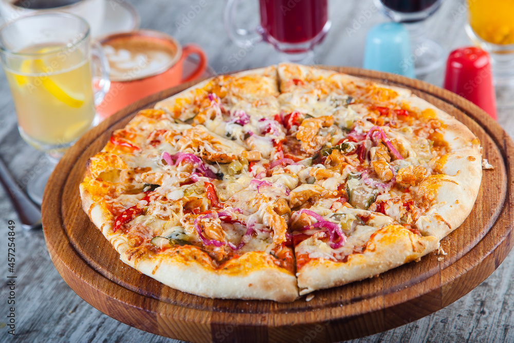 pizza stuffed with tomatoes and cheese on a wooden table pizza stuffed with tomatoes and cheese on a wooden table