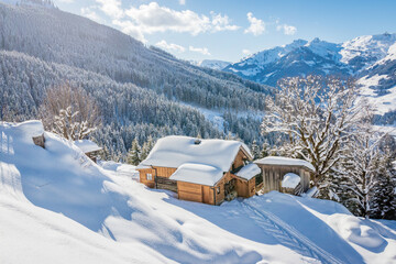 Beautiful winter mountain landscape with snowcapped wooden hut