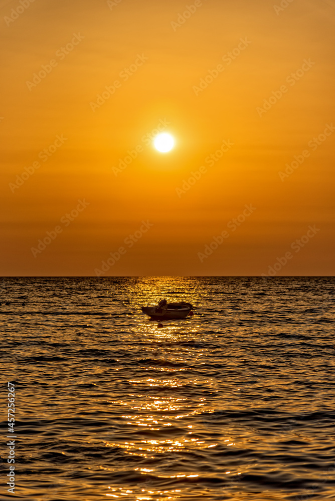 A boat at sunrise on the Adriatic Sea