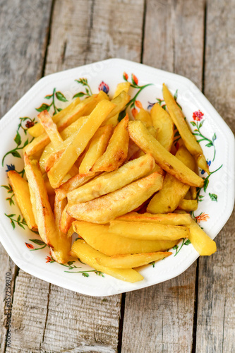  Home made   Fresh fried French fries  in a bowl on wooden rustic  background