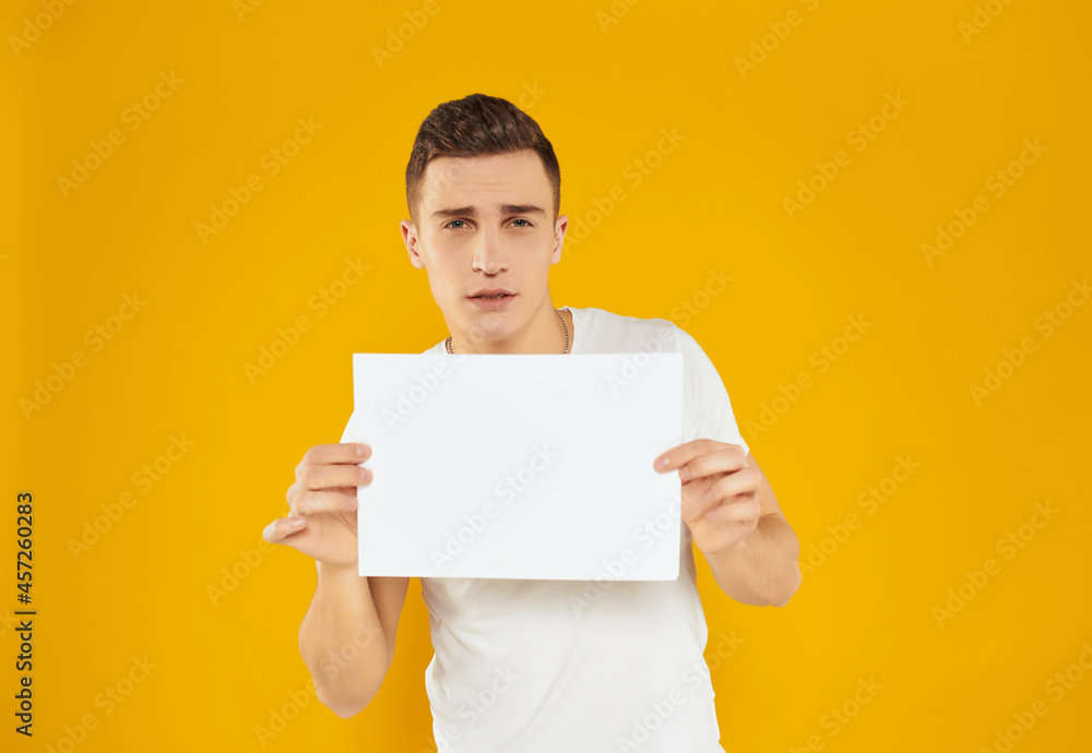 Cheerful man in white t-shirt sheet of paper copy space advertisement Cheerful man in white t-shirt sheet of paper copy space advertisement