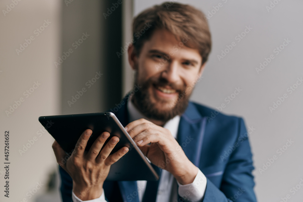 business man in a suit with a tablet in the hands of a technology manager business man in a suit with a tablet in the hands of a technology manager
