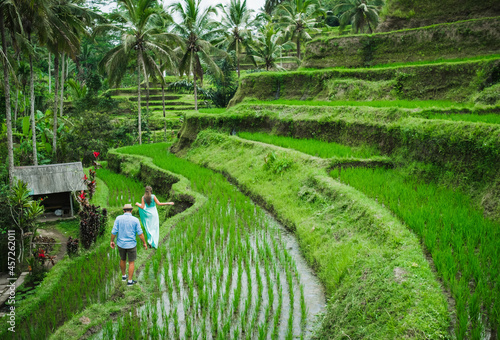 Сouple in love walking in a rice field, Bali, Indonesia. photo