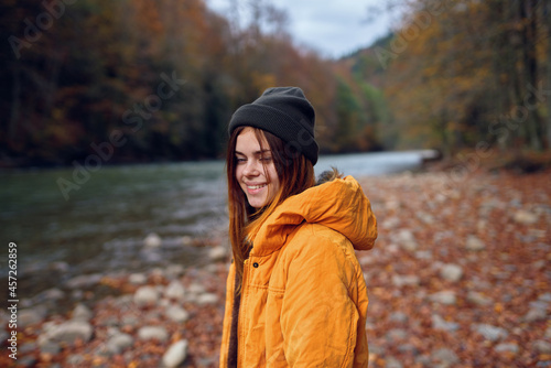 woman in yellow jacket on nature travel river autumn © SHOTPRIME STUDIO