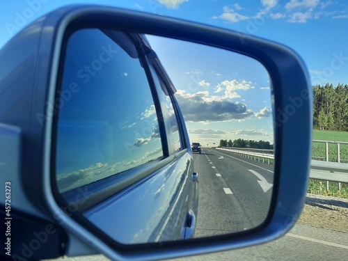 the road is reflected in the mirror