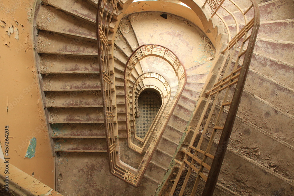 A staircase in an old, empty building.