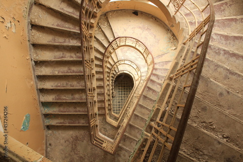 A staircase in an old, empty building.