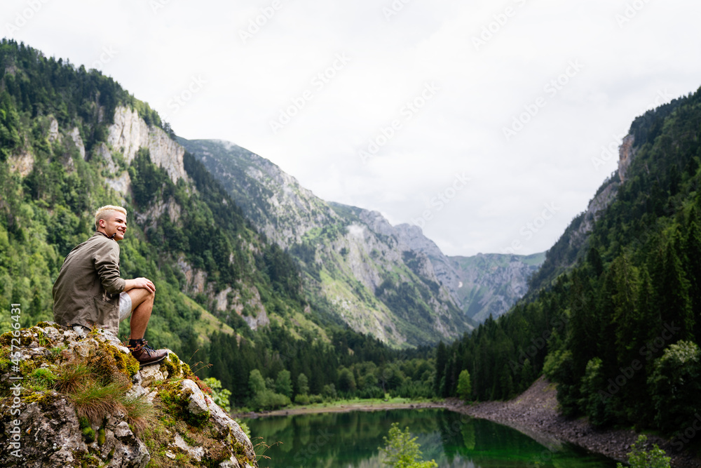 Traveler man relaxing with view mountains and lake landscape Traveler man relaxing with view mountains and lake landscape