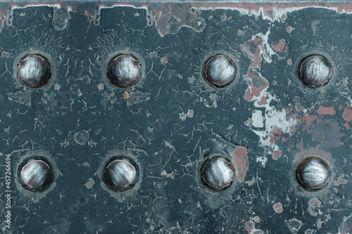 Close-up horizontal image top view grunge metal with rivets on metal plate.