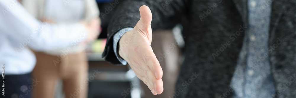 Businessman stretches out his hand for handshake