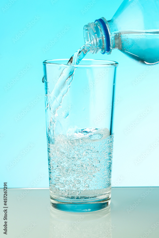 water pouring into a glass close up. filling a glass with clean water from a bottle water pouring into a glass close up. filling a glass with clean water from a bottle