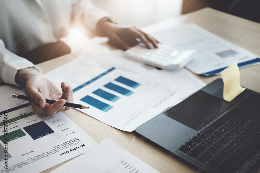 focus woman holding a pencil Auditors use budget document calculators to find annual budget disbursement errors. focus woman holding a pencil Auditors use budget document calculators to find annual budget disbursement errors.