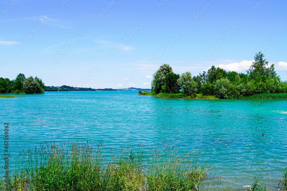 Forggensee near Füssen. Blue lake with surrounding landscape in the Bavarian Allgäu. Forggensee near Füssen. Blue lake with surrounding landscape in the Bavarian Allgäu.