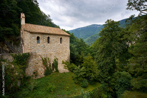 Stone house in the mountains surrounded by green vegetation