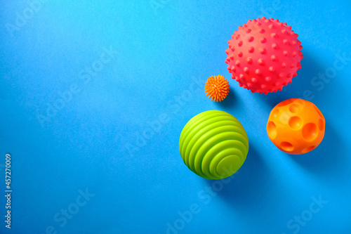 Baby massage balls on a blue background, place for an inscription