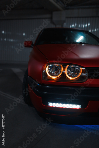 Red car with new headlight optics and tuning in the parking lot © alones