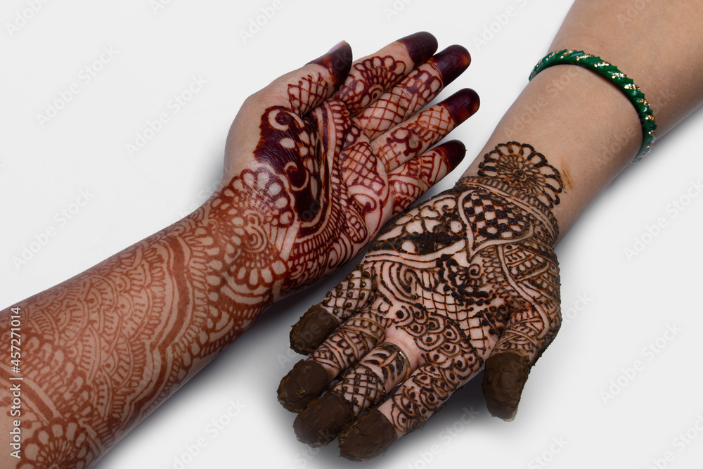 Mehndi Heena or Henna Design Is Indian And Arabic Tradition. Temporary Body Art is Drawn on Hand, Subh Teez Pooja, Hariyali Teej Puja , Karva Karwa Chauth Vrat Raksha Bandhan And Eid. White Background Mehndi Heena or Henna Design Is Indian And Arabic Tradition. Temporary Body Art is Drawn on Hand, Subh Teez Pooja, Hariyali Teej Puja , Karva Karwa Chauth Vrat Raksha Bandhan And Eid. White Background