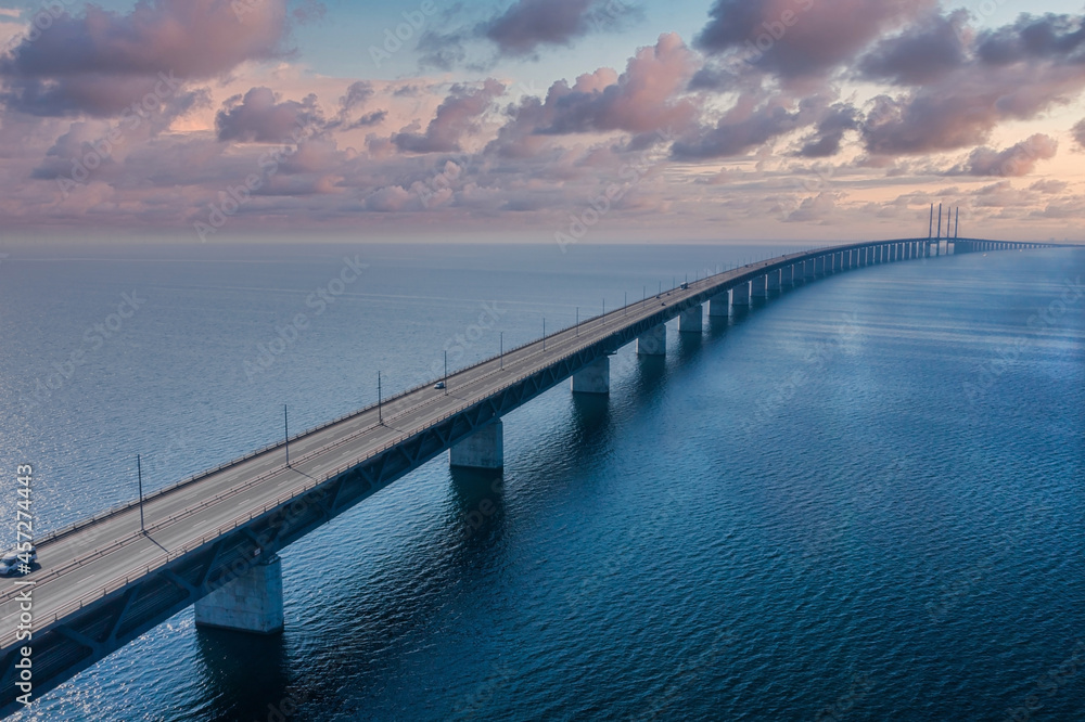 Panoramic aerial view of the Oresundsbron bridge between Denmark and Sweden. Oresund Bridge view at sunset. Panoramic aerial view of the Oresundsbron bridge between Denmark and Sweden. Oresund Bridge view at sunset.