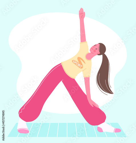 Aerobic, fitness and yoga classes. Beautiful girl stands in Trikonasana triangle pose. Concept of  healthy lifestyle.