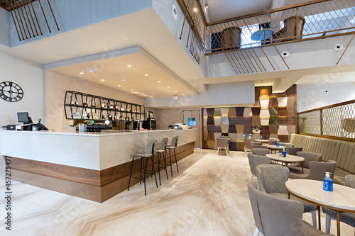 Interior of a spacious cafe bar in hotel lobby photo