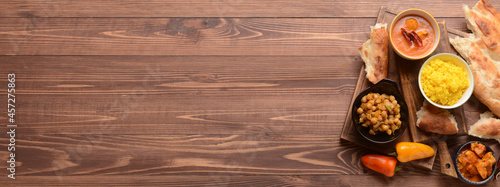 Traditional Indian food on wooden background with space for text