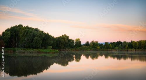 Beautiful morning clouds reflected in a small lake in Burgenland
