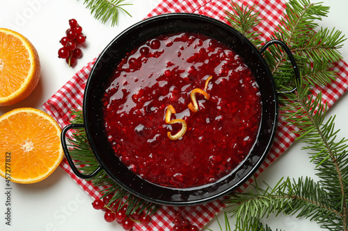 Concept of tasty food with cranberry sauce on white background