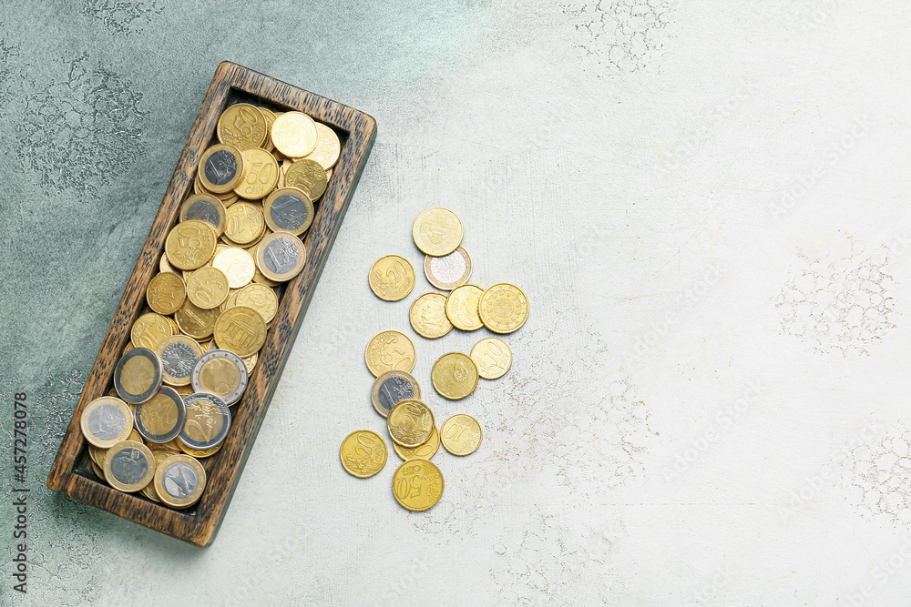 Tray with coins on grunge background Tray with coins on grunge background