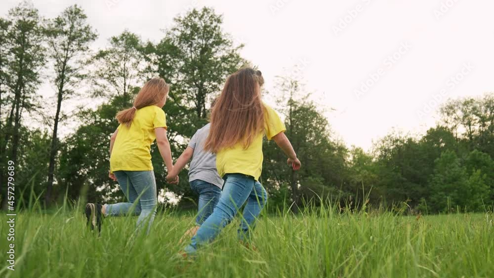 Young team of children. Group of children run in park on grass. Team play in park. Teamwork concept Children run on green grass. Kids team run in park. Kids play in natural park.Group of kids teamwork Young team of children. Group of children run in park on grass. Team play in park. Teamwork concept Children run on green grass. Kids team run in park. Kids play in natural park.Group of kids teamwork