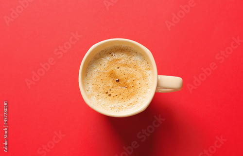 Cup of coffee on red background