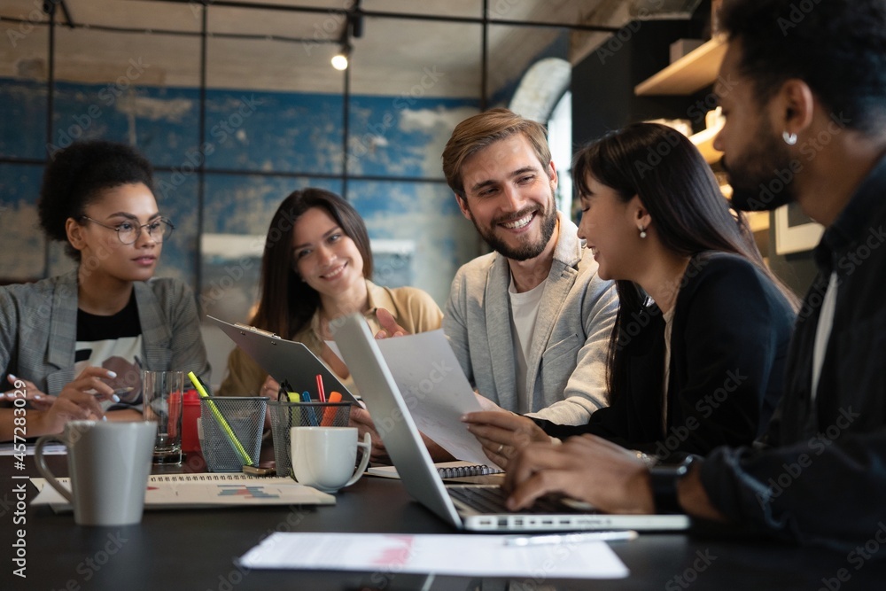 Group of young multiracial people working in modern office. Businessmen at work during meeting. Group of young multiracial people working in modern office. Businessmen at work during meeting.