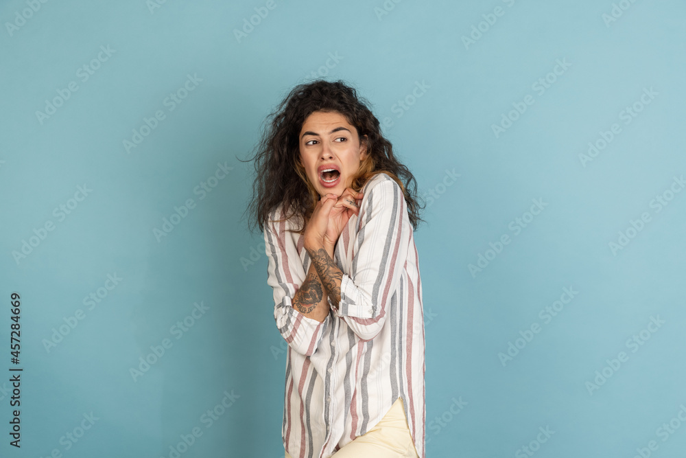Half-length shot of beautiful girl, fashion female model with tattoo on her hands isolated on light blue studio background. Concept of emotions, feelings Half-length shot of beautiful girl, fashion female model with tattoo on her hands isolated on light blue studio background. Concept of emotions, feelings