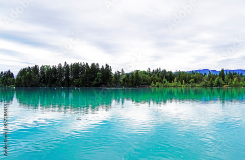 Lech reservoir in Lechbruck am See. View of the lake with the surrounding nature. Reflection in the water.