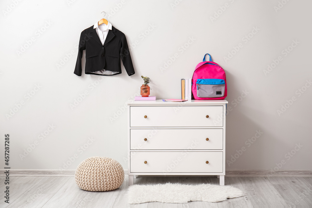 Fototapeta premium Interior of room with chest of drawers and school uniform